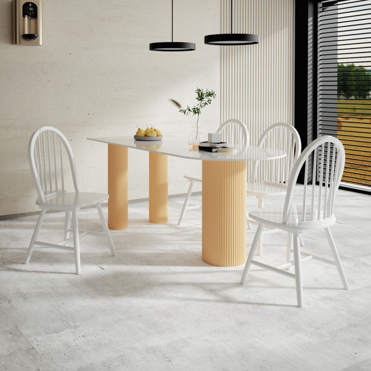Vintage Windsor wood dining chairs in white with spindle back design, offering comfort and durability for dining rooms.